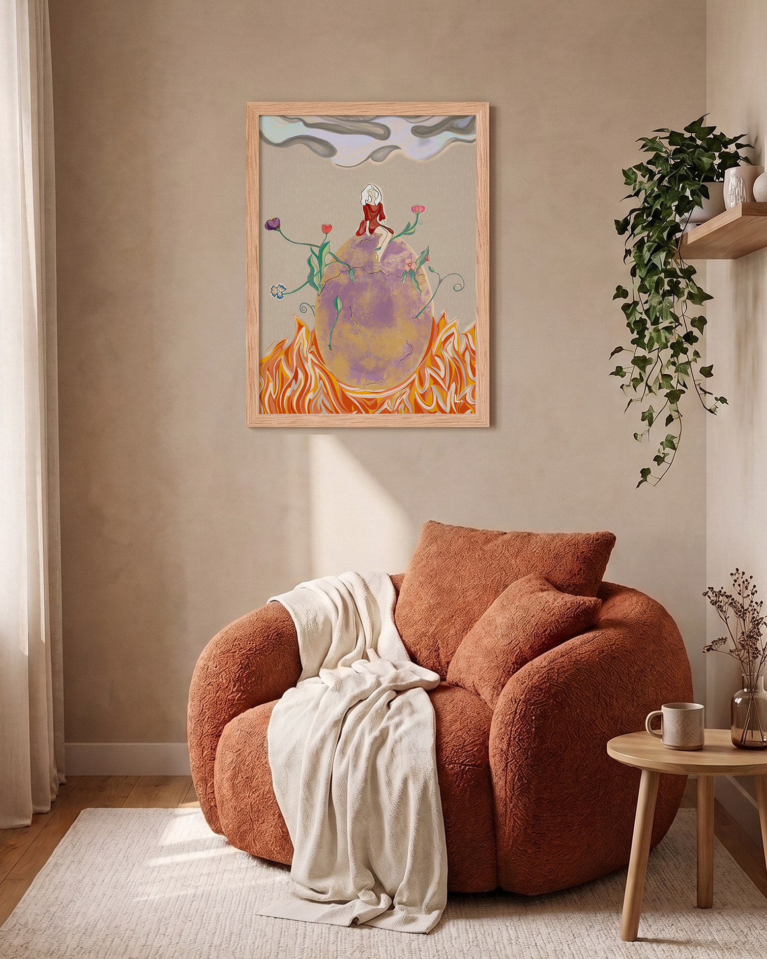 A framed abstract art print hangs on a beige wall above a terracotta-colored boucle armchair in a styled living room setting with a side table, plant, and curtains.